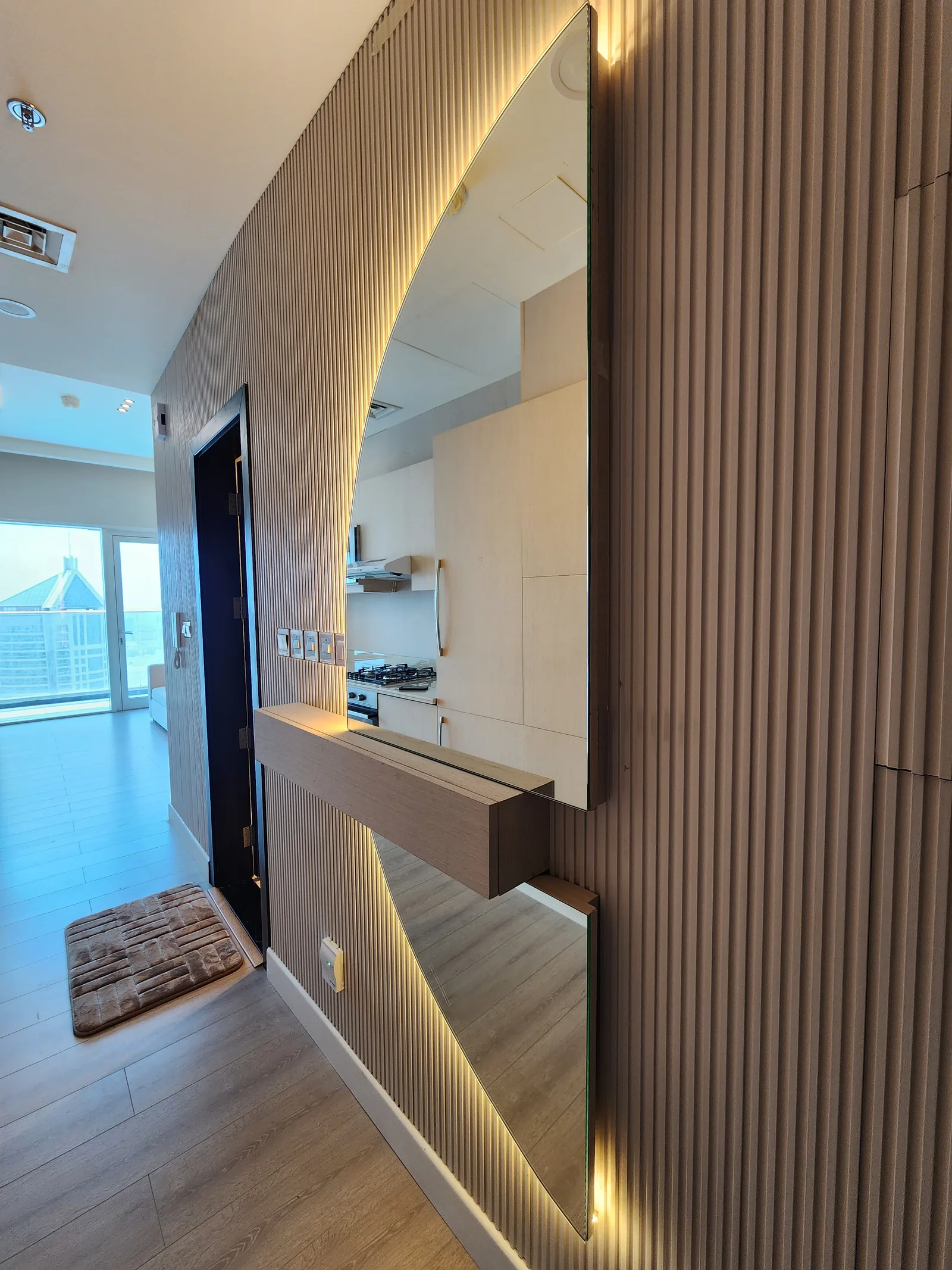 Angled view of the entrance mirror and fluted panels.