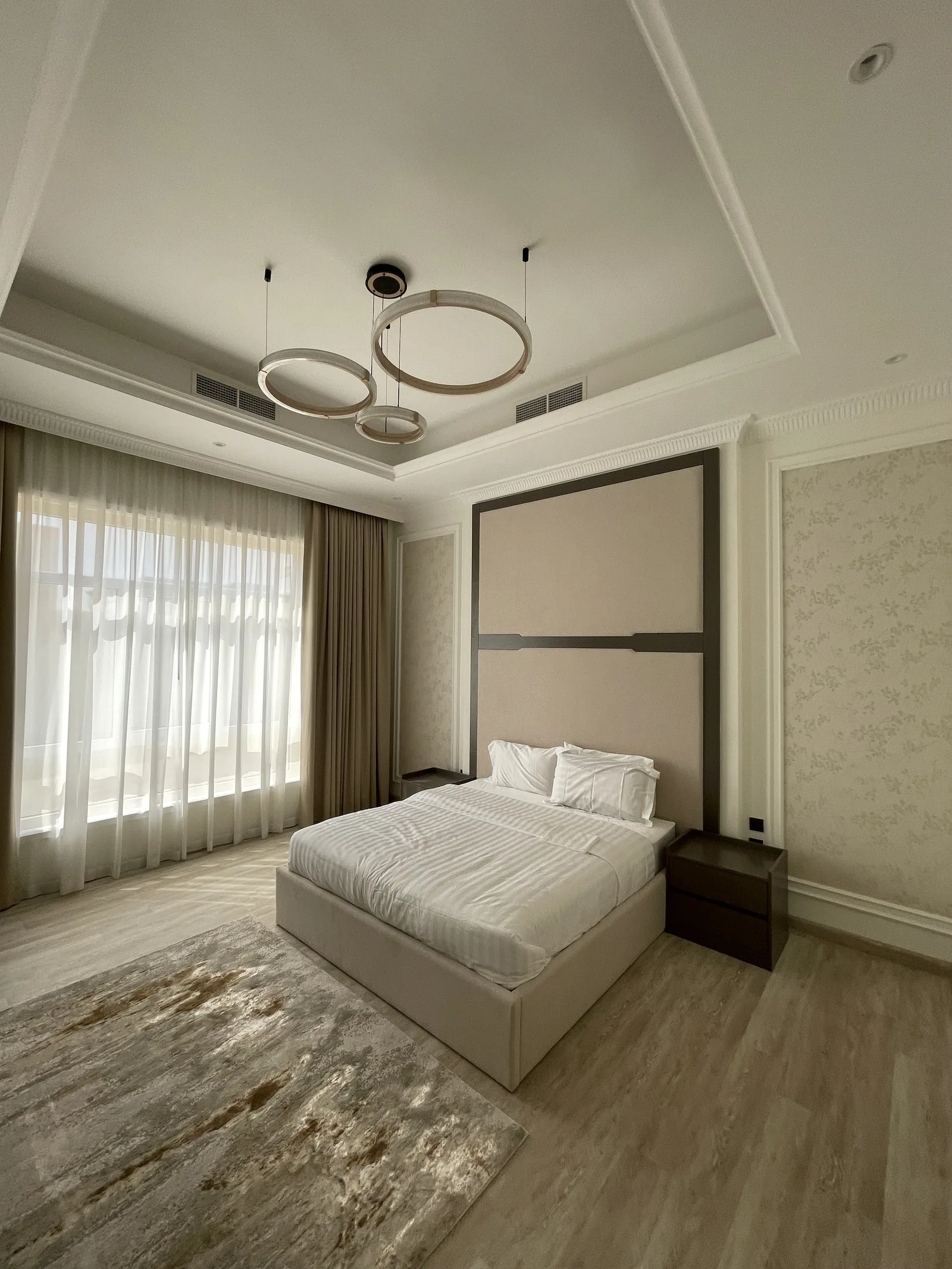 Full-height framed upholstered headboard and bed.