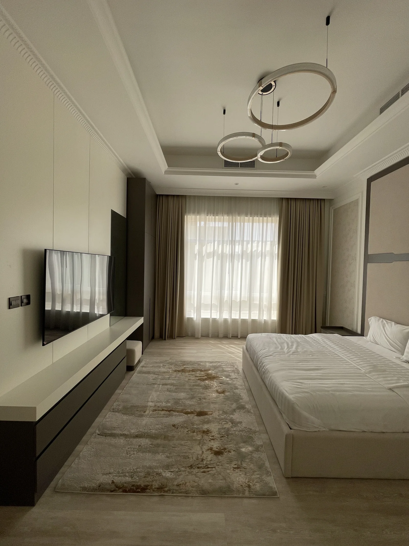 Bedroom circulation and coordinated bed/media wall.