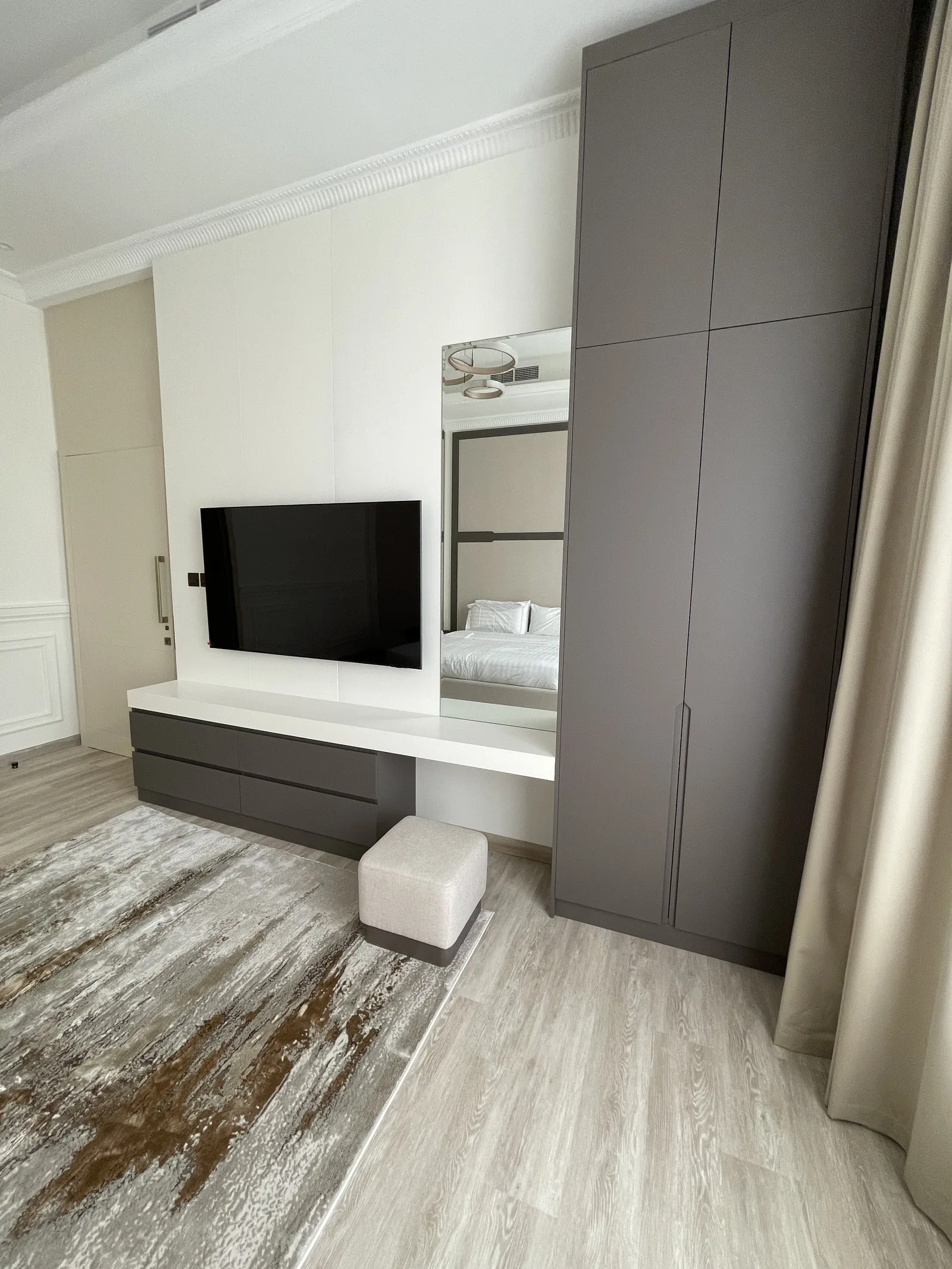 Integrated media console, mirror and tall storage.