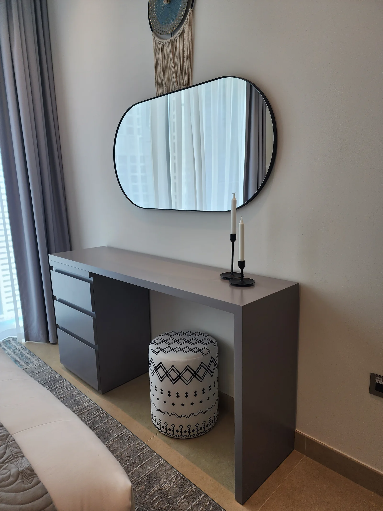 Dressing table, organic mirror and patterned stool.