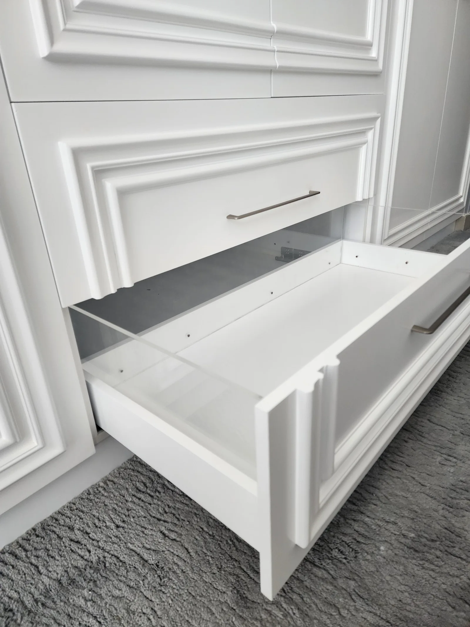 Empty pull-out drawer with glass sides.