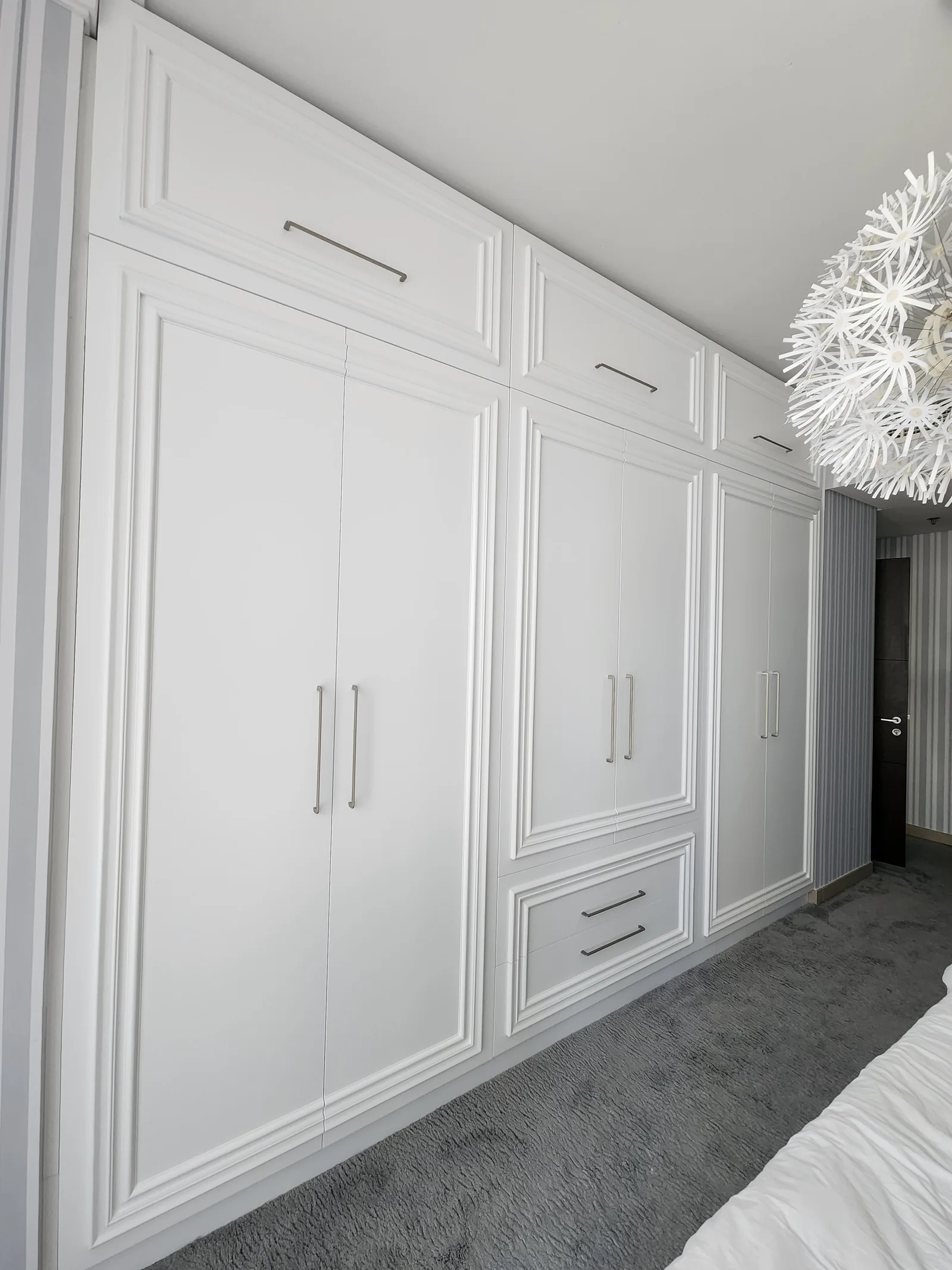 Full-height fitted panelled wardrobe.