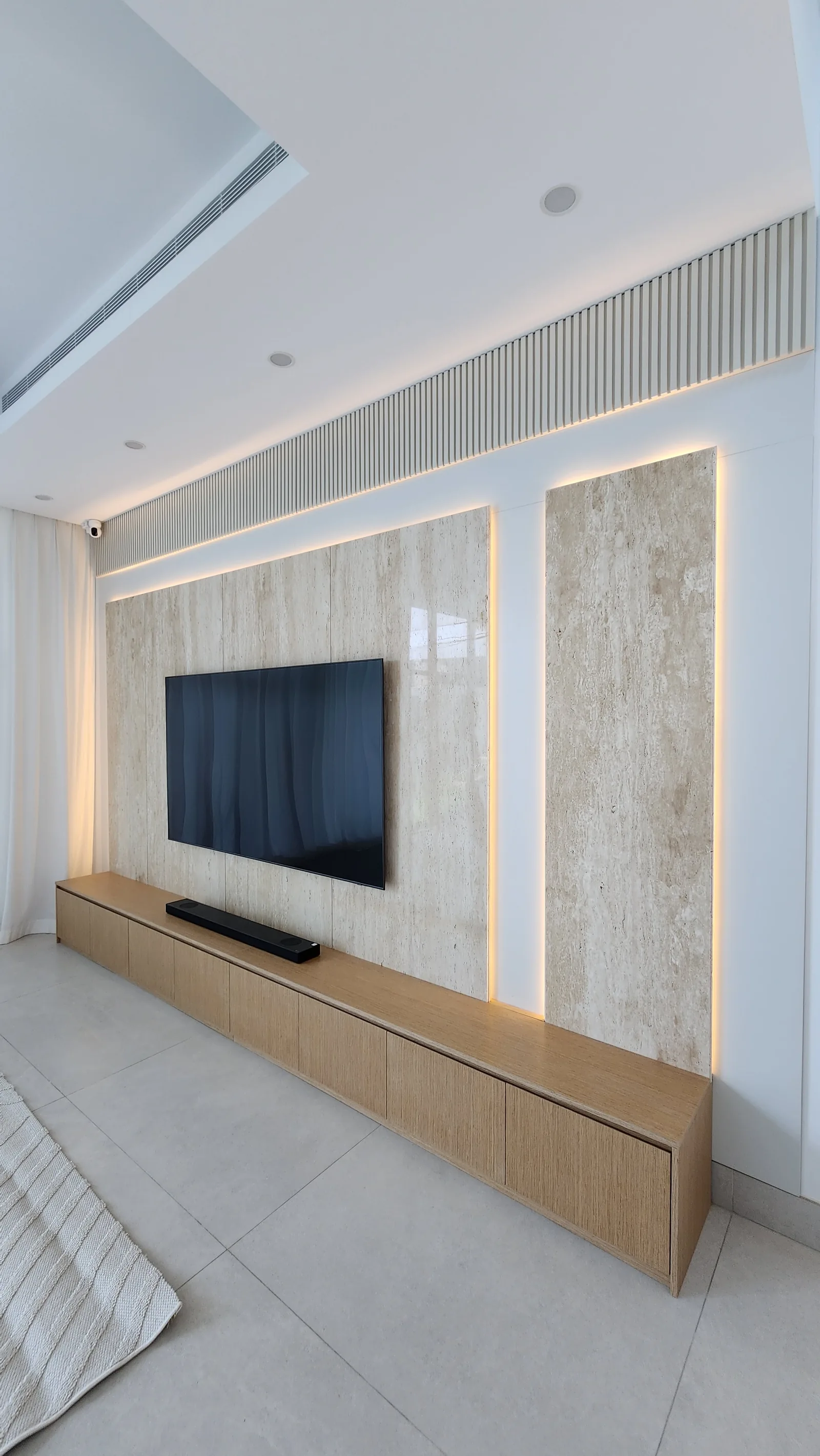 Close joinery view of media wall and timber-toned console.