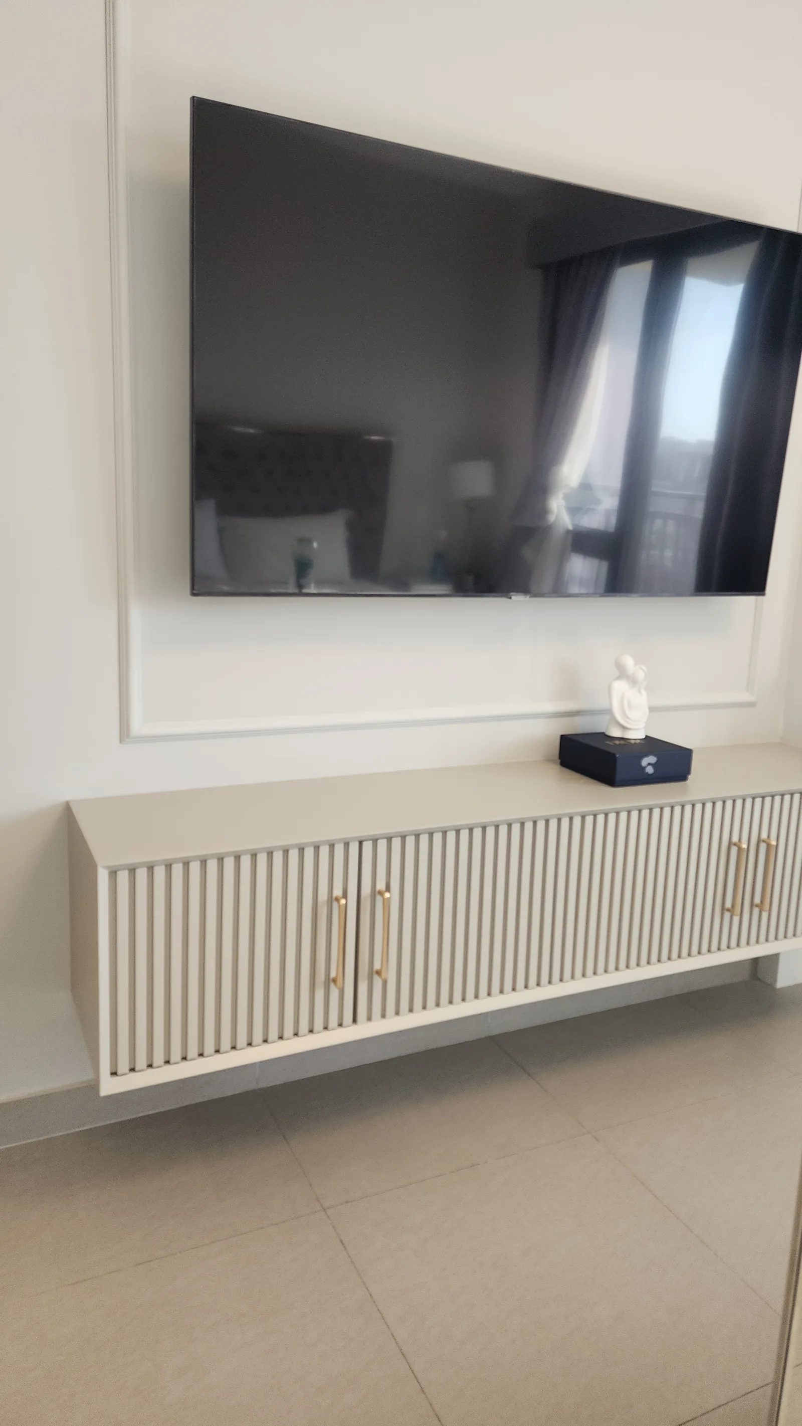 Bedroom TV surround and fluted floating console.