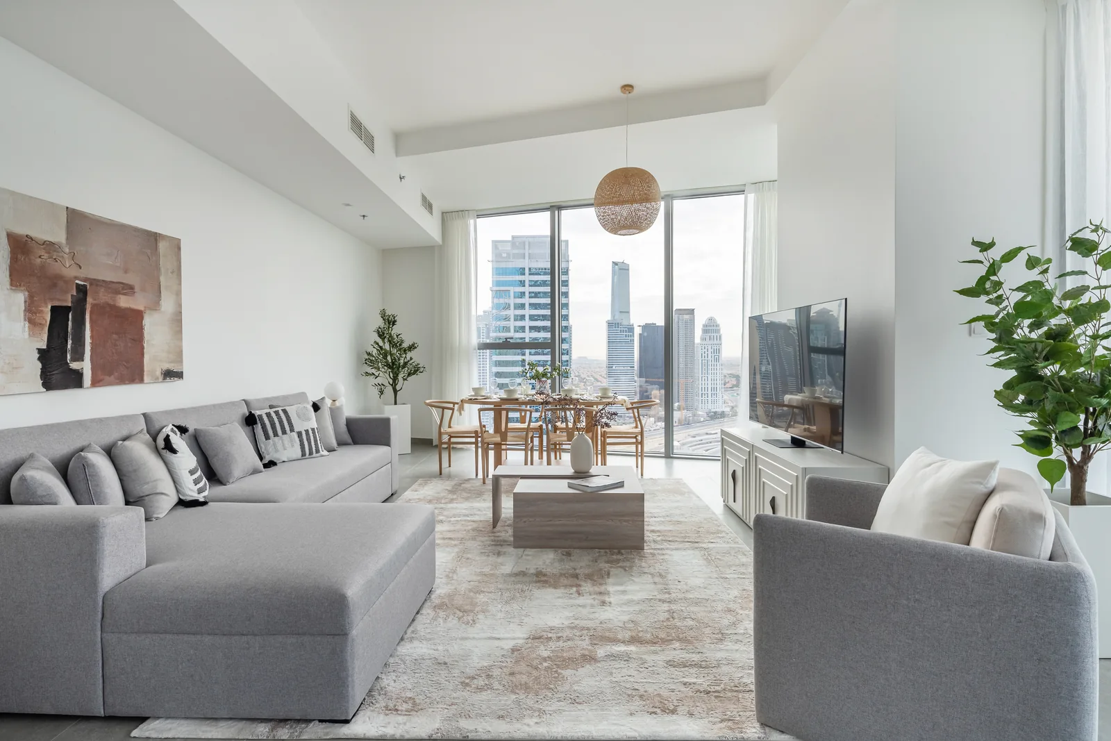 Grey living room and timber-toned dining setting.