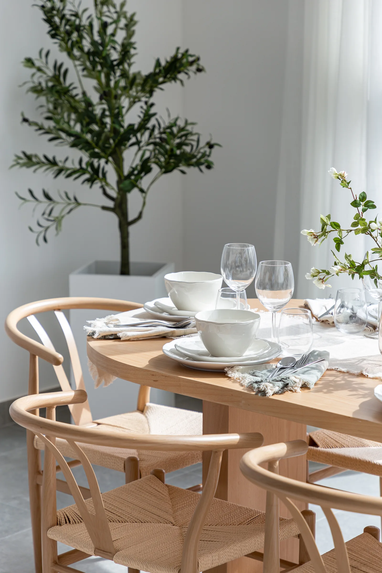 Woven dining chairs and coordinated table setting.