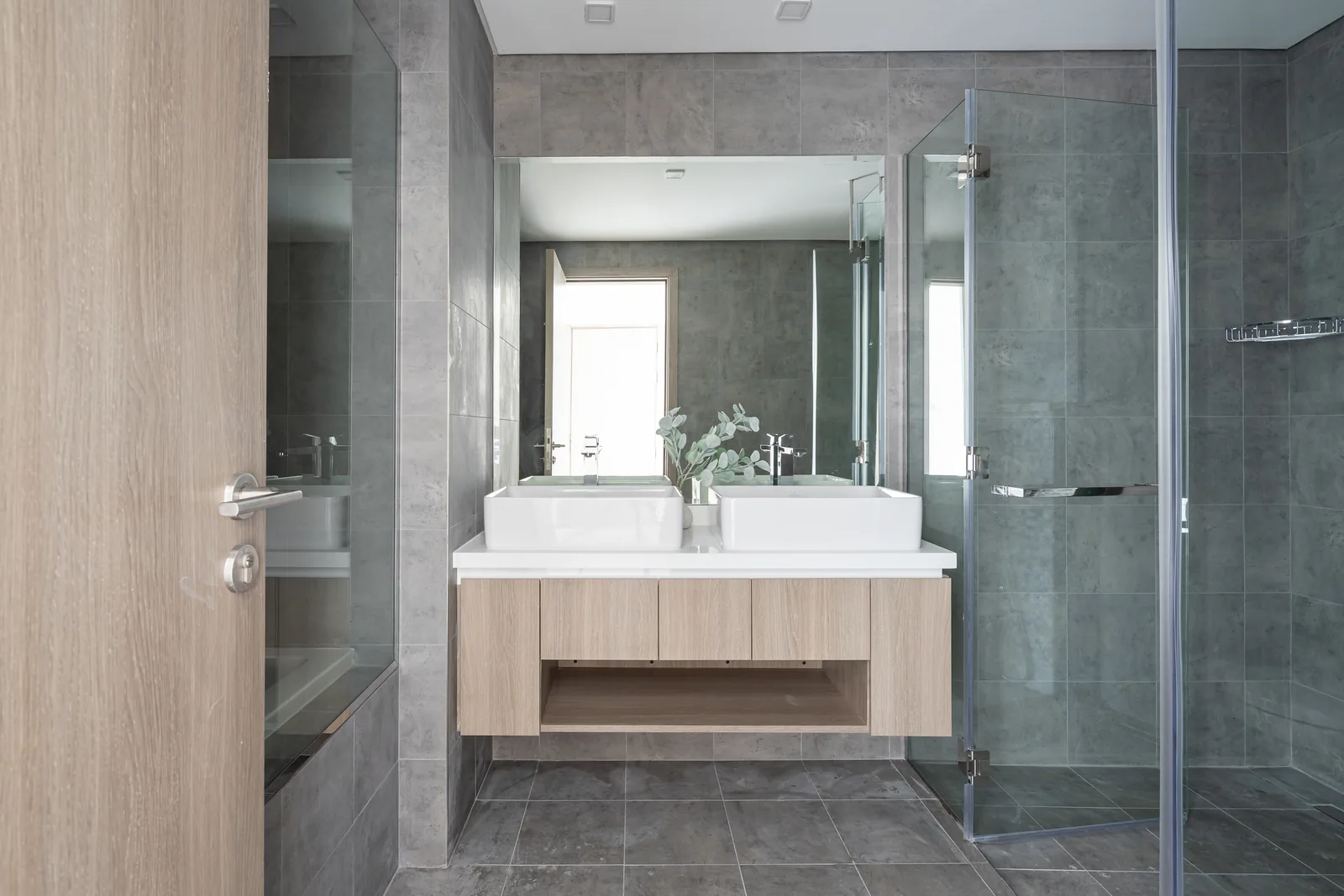 Double vanity and glass shower enclosure.
