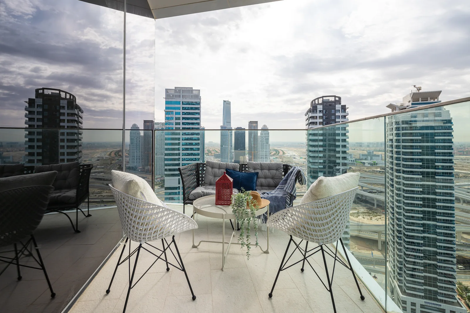 Second balcony seating group with woven furniture.