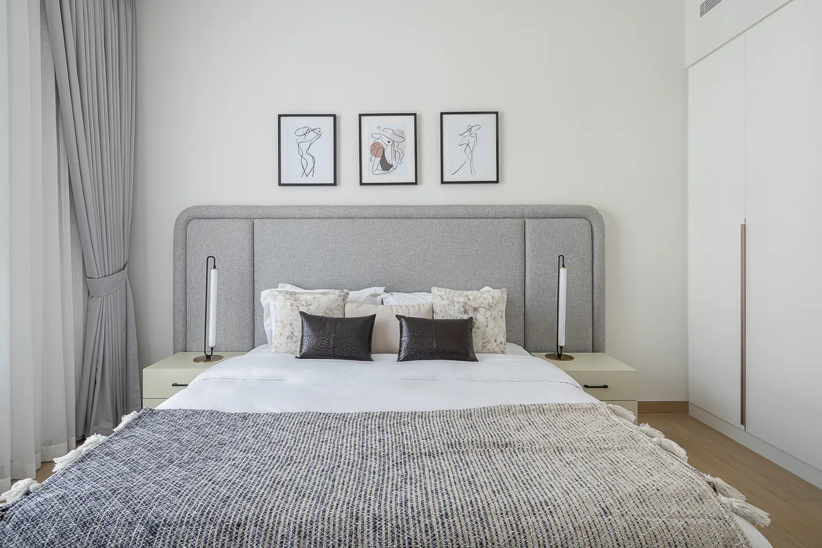 Symmetrical bed, headboard and bedside tables.