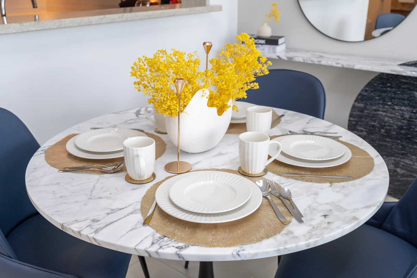 Dining-table material, place settings and gold-toned accents.