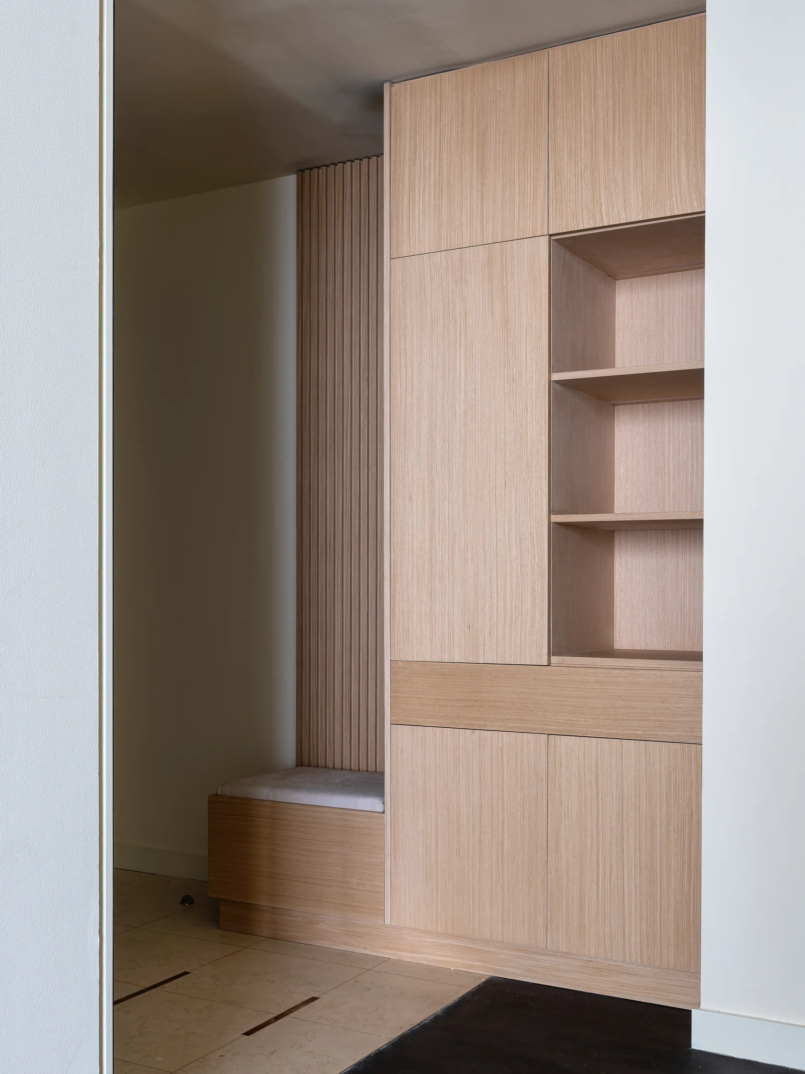 Entry cabinetry, open shelves and integrated bench.